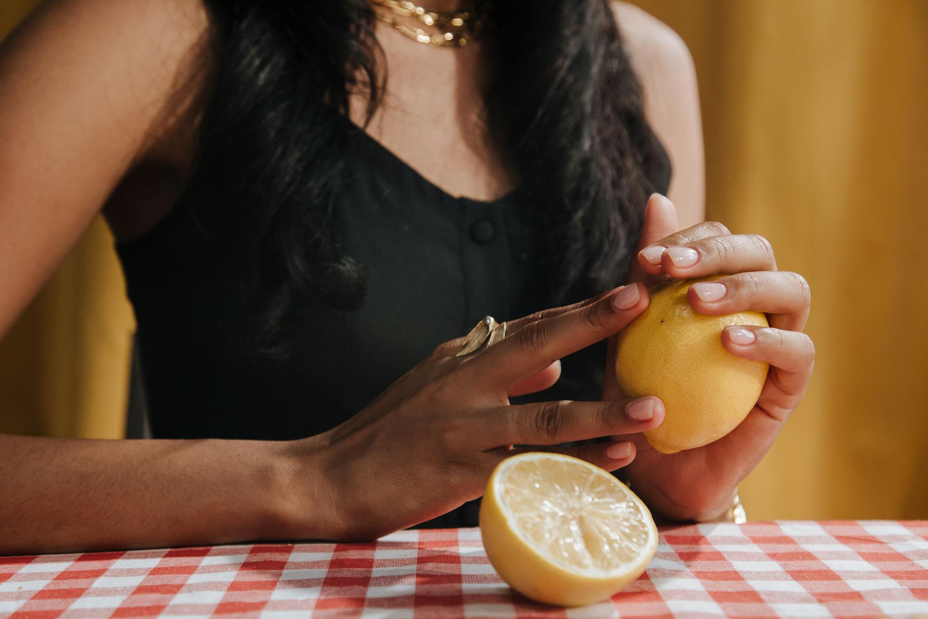 Woman holding a fresh lemon, symbolizing the gradual return of sensation and vitality