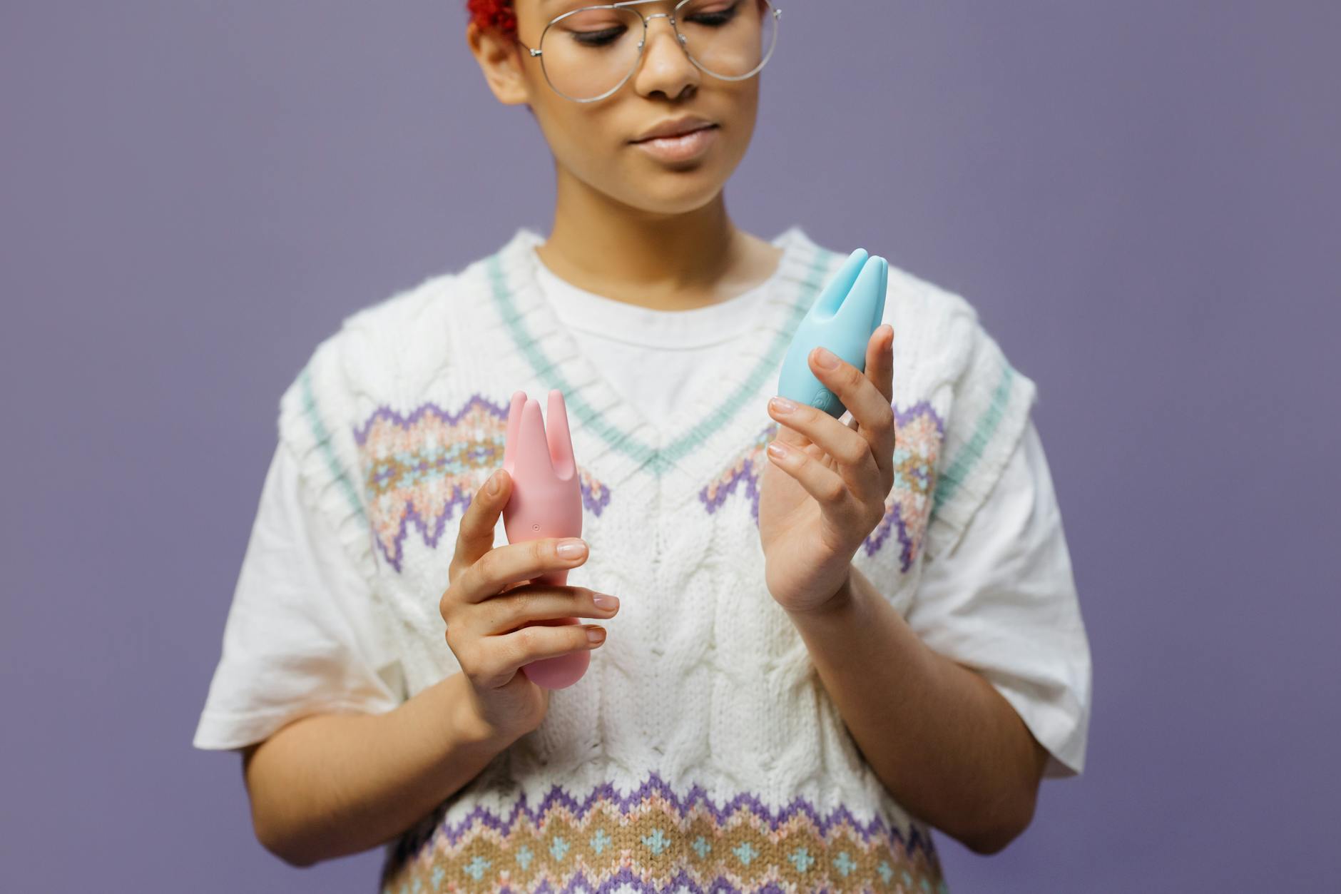 Woman in contemplative moment holding silicone vibrator, representing intentional solo pleasure and self-awareness